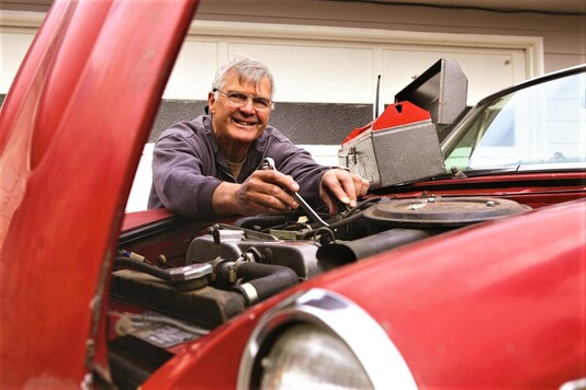 Mężczyzna naprawia silnik auta